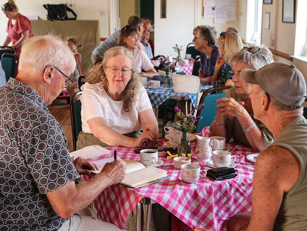 Villagers in Frampton Mansell Village Hall during a Village of the Year judging visit
