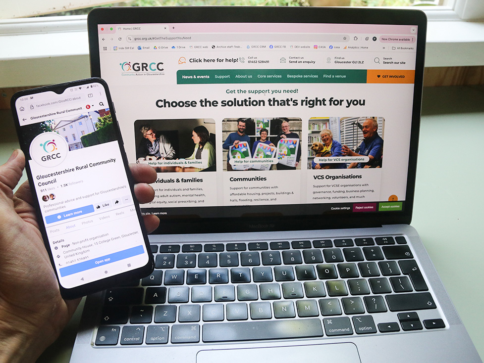 We're recruiting! Photo of a phone and laptop showing GRCC website