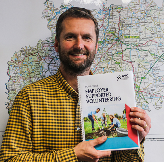 Guy Dobson with the Employer Supported Volunteering Guidebook produced by the Gloucestershire Volunteering Collaborative