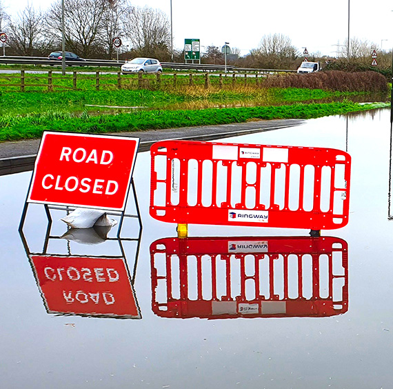 Photo of flooding and Road Closed sign