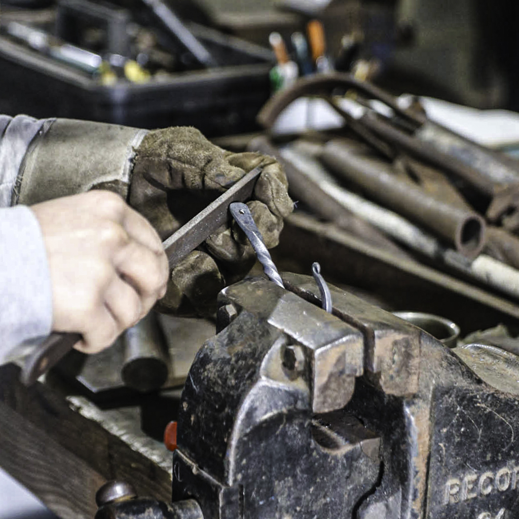 blacksmithing students working in the forge