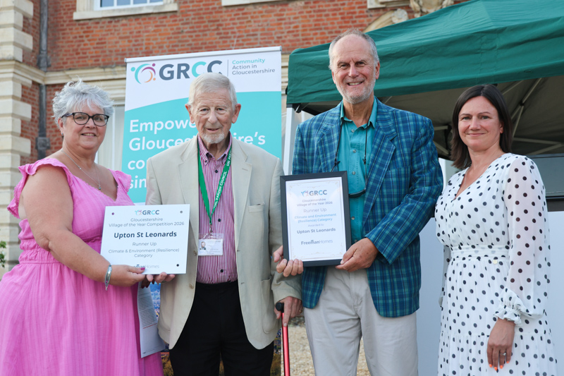 Representatives of Upton St Leonards receive their prize from two of the competition judges