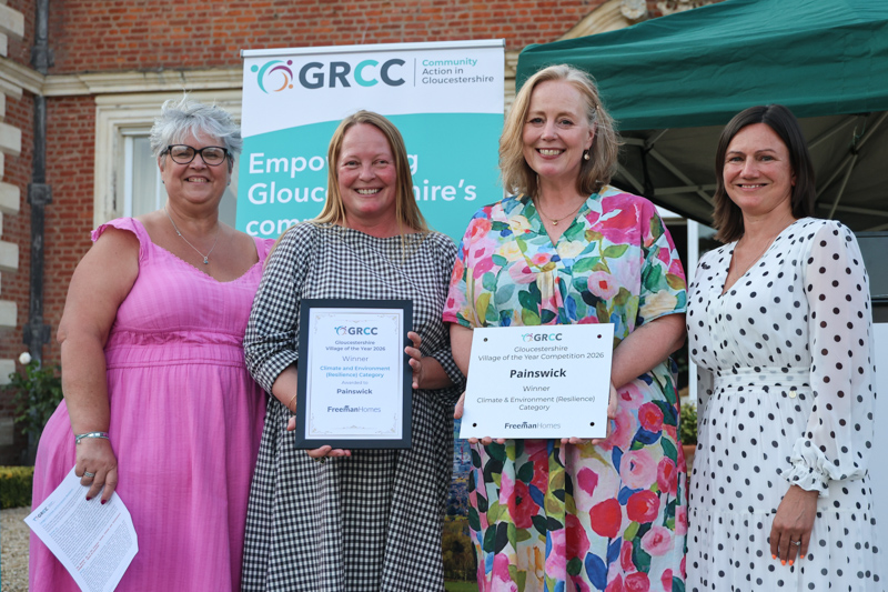 Representatives of Painswick receive their prize from two of the competition judges