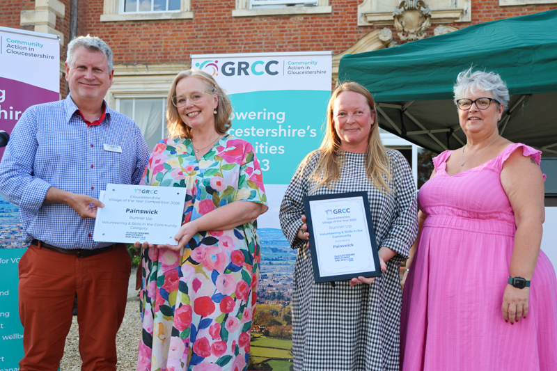 Representatives of Painswick receive their prize from two of the competition judges