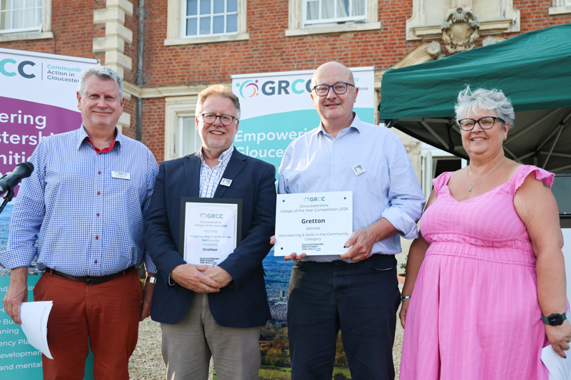 Representatives of Gretton receive their prize from two of the competition judges