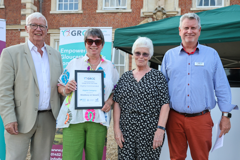 Representatives of Westbury on Severn receive their prize from two of the competition judges