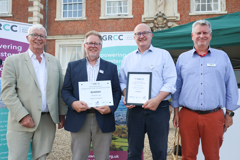 Representatives of Gretton receive their prize from two of the competition judges