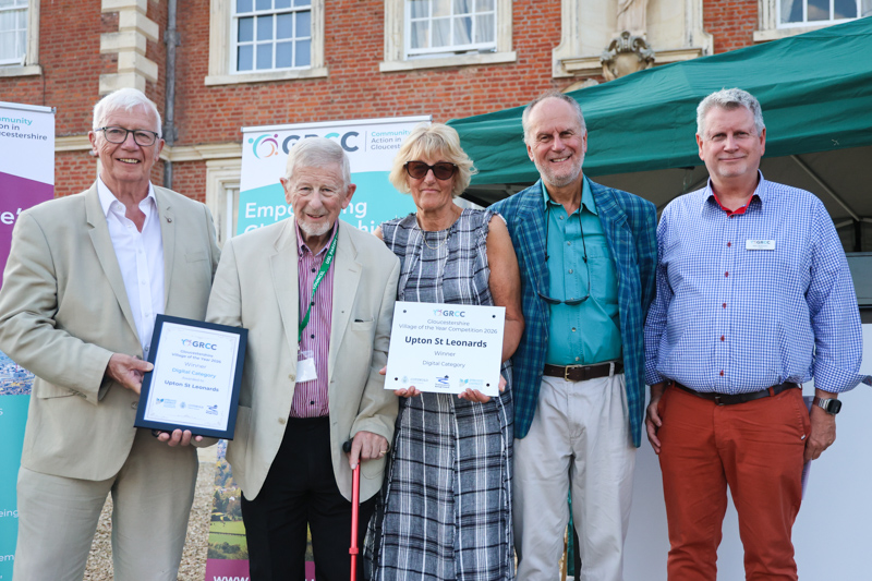 Representatives of Upton St Leonards receive their prize from two of the competition judges