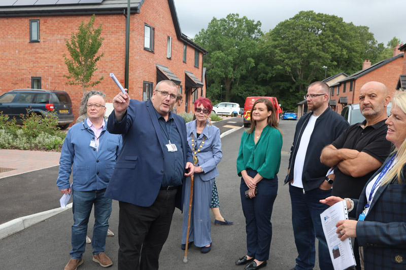 Tim Gwilliam MBE outlines the history of the Whitehall Close affordable rural housing development to Jenny Riddell-Carpenter MP